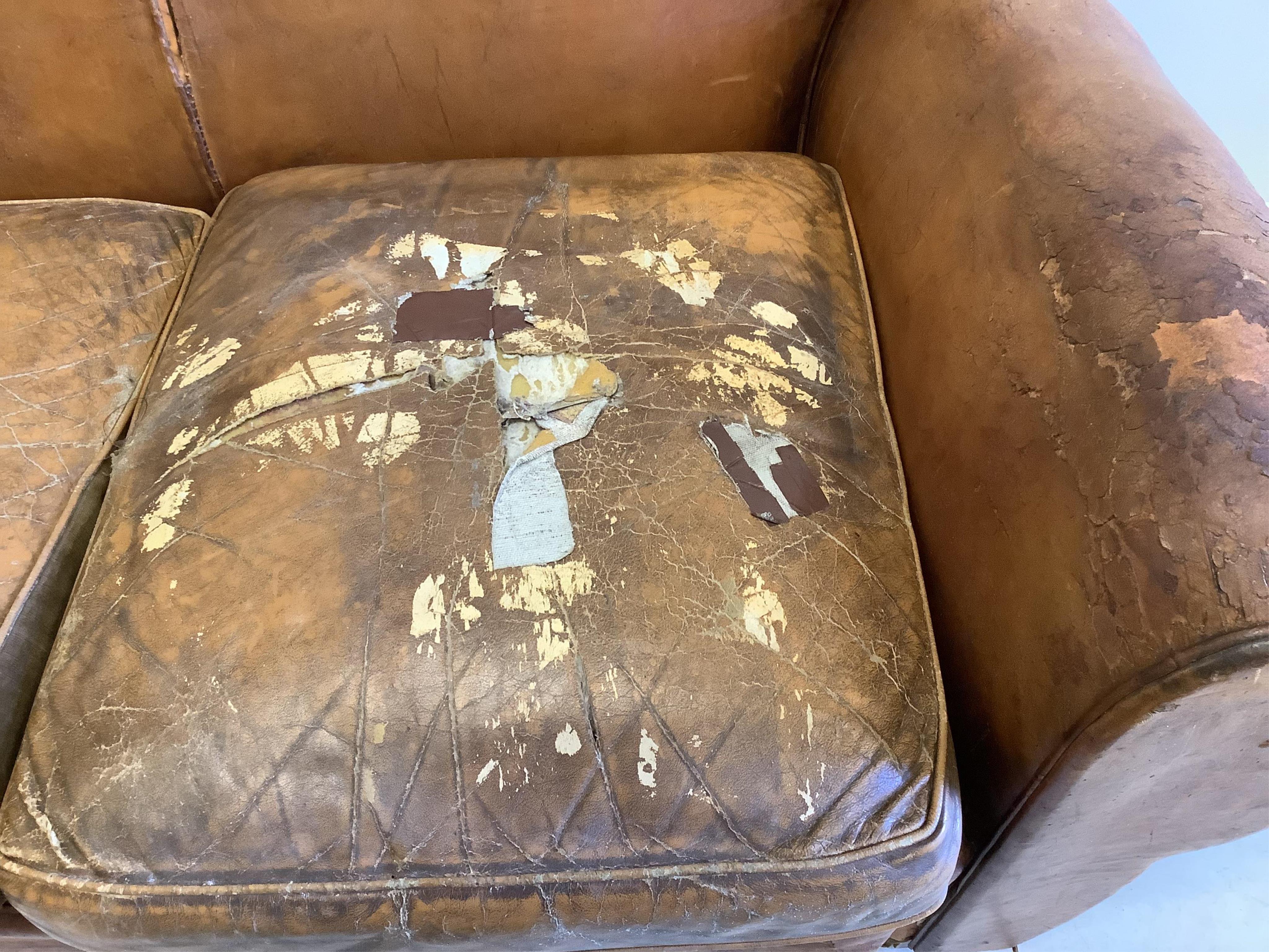 A French leather moustache back sofa, width 148cm, depth 80cm, height 80cm